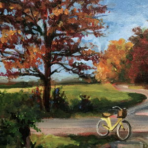 Autumn scene of a road with a bright yellow bicycle stopped alongside.