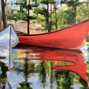 Two canoes, one red and one white sit on a still lake. The canoes as well as the trees on the shore behind them are reflected in the water in the foreground.