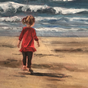 Small girl wearing a red dress runs towards waves on a beach on a sunny day.