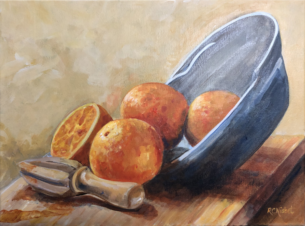 Still life of a bowl on its side with 3 full oranges and one orange that has been cut in half and juiced. There is a wooden juice reemer on the left hand-side.