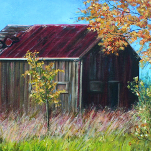 Small barn or outbuilding in a field. Part of the roof is missing. It is an early autumn day.