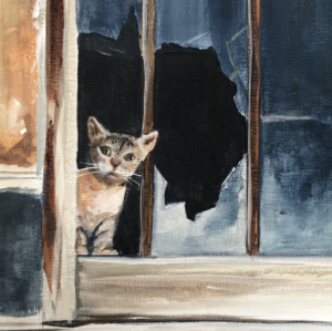 A small cat peaks out of a broken window on  the side of a building. There is another cat behind the glass to the right.