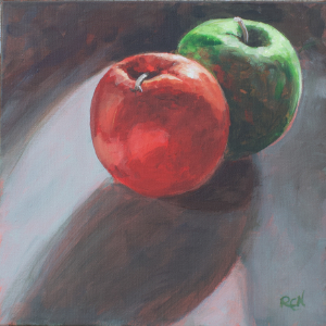 A red and a green apple on a dark background, the apples have long shadows in the front.